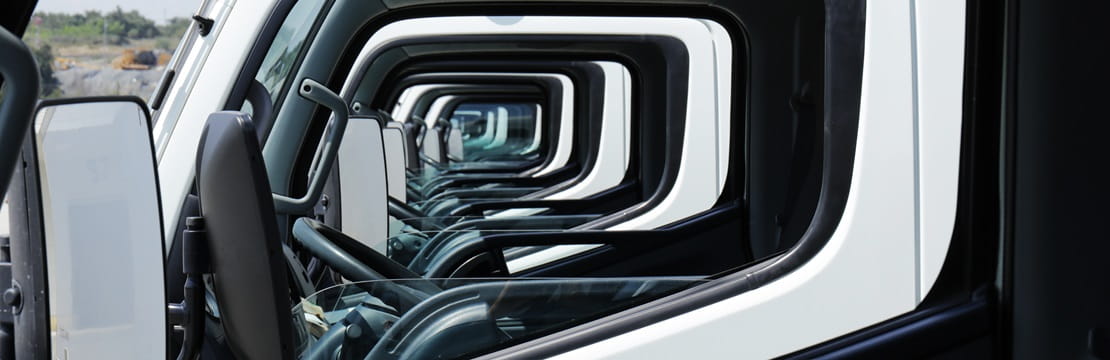 Stylish photo taken through the front driver-side window of a row of service vehicles